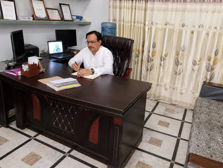 Javed Hajana at his office desk